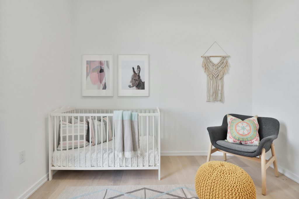 An empty cot in a white room